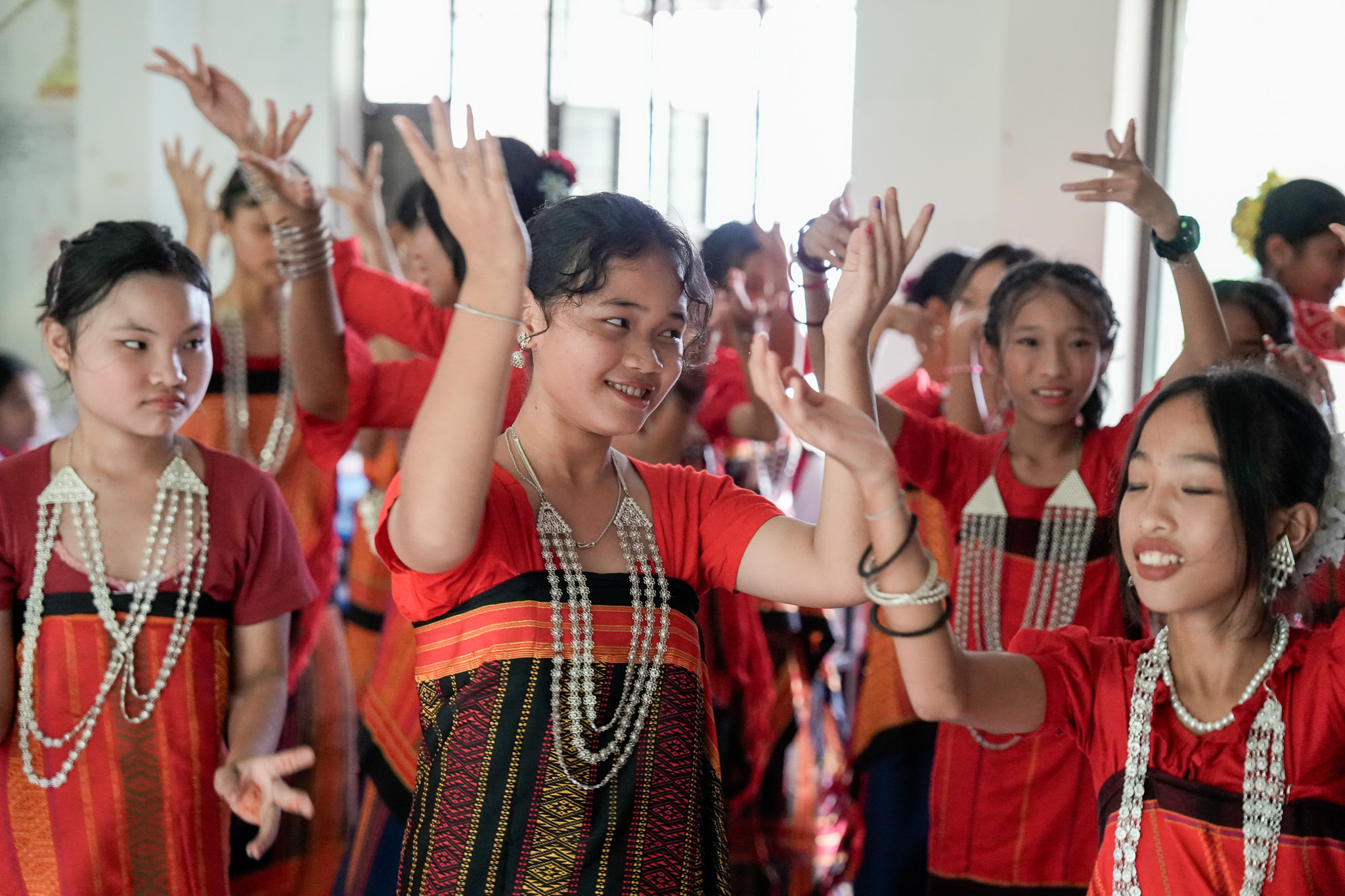 Students in traditional attire performing a dance